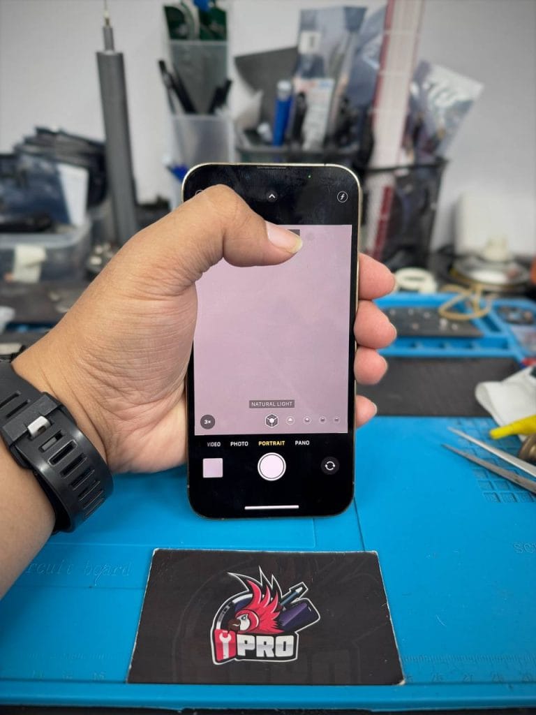 Technician is pointing at a black dot while using the camera